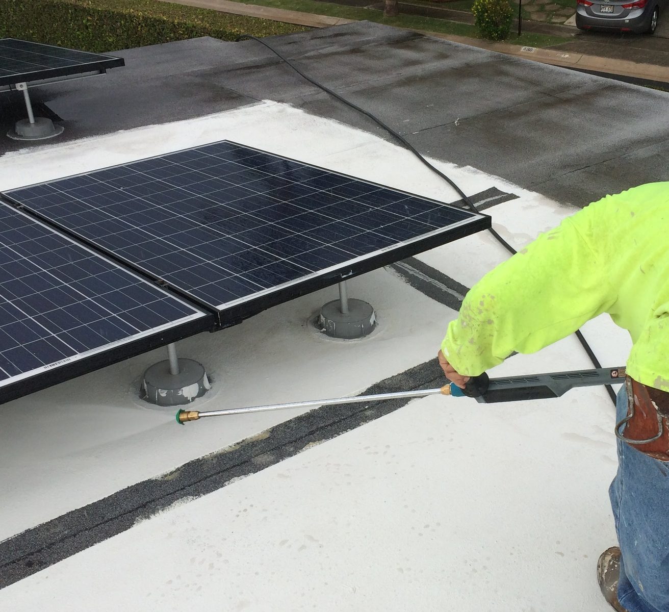 Pressure washing solar panels on residential roof